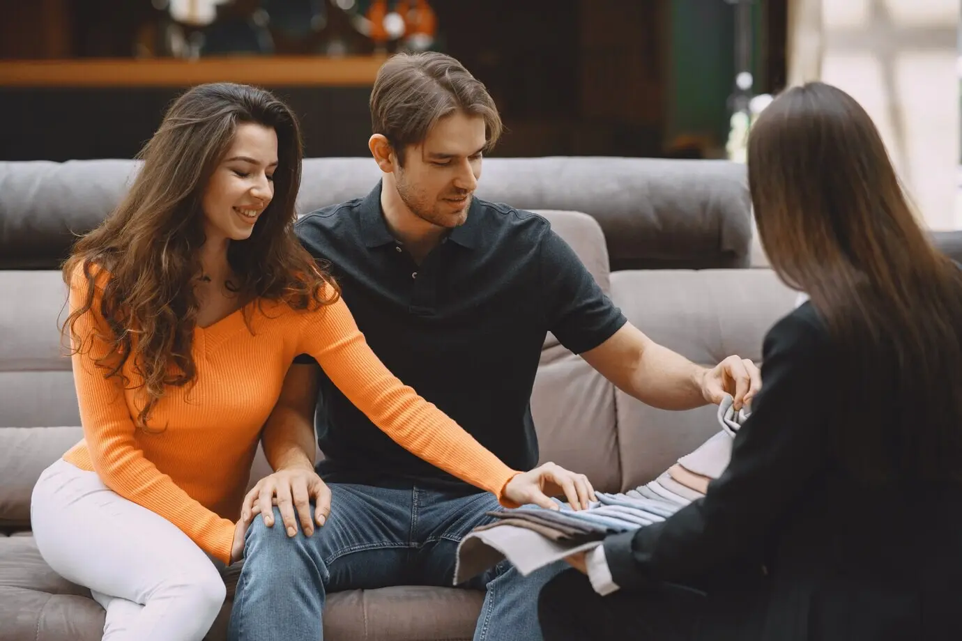 Ein Paar wählt im Möbelgeschäft Stoff aus.